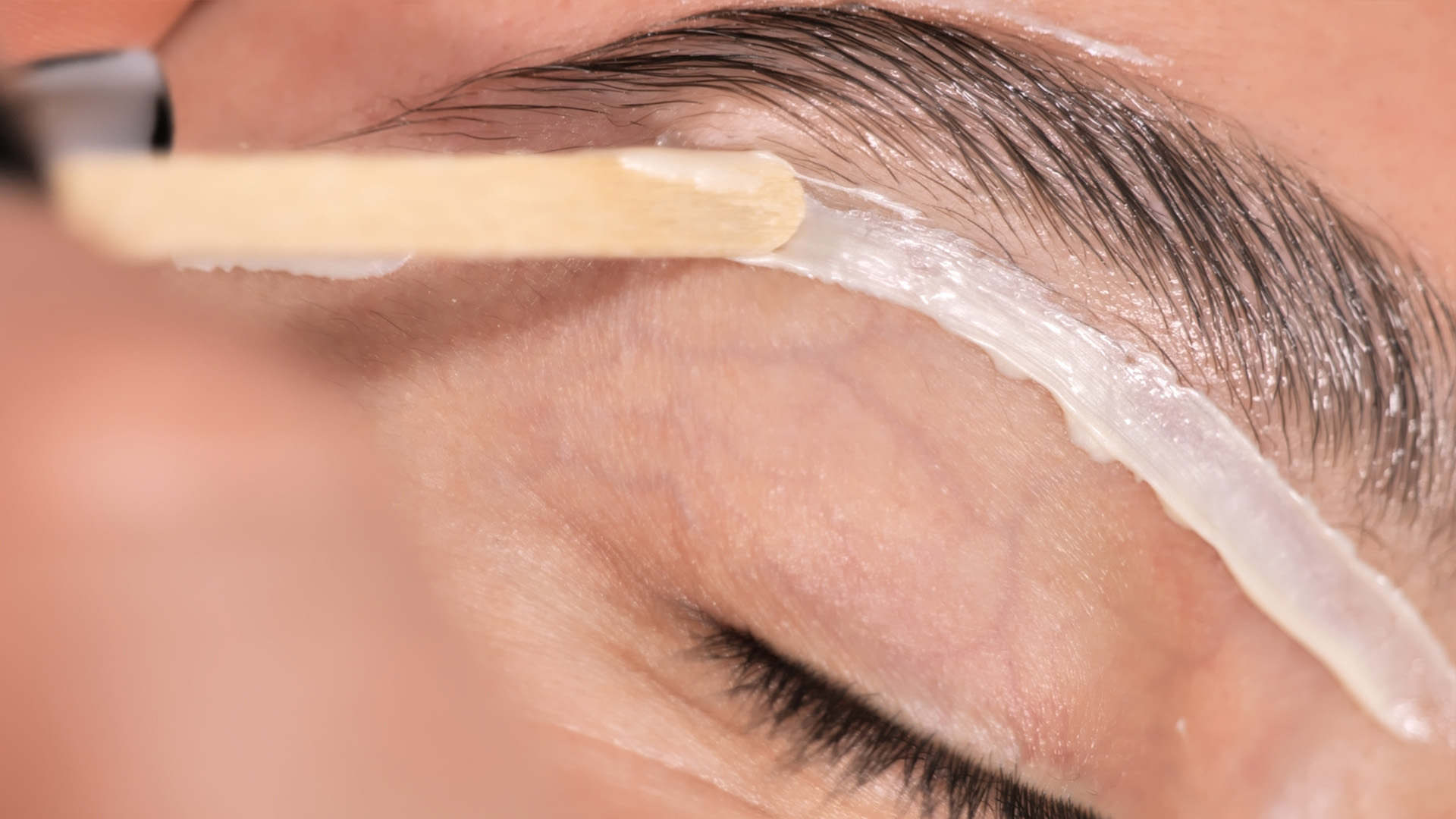 Eyebrow Shaping: Waxing vs Threading. Image of an eyebrow wax for our beauty blog post about brow waxing vs brow threading.
